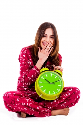 0168-teenager_sitting_with_alarm_clock.jpg