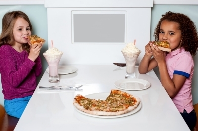 0382-little_girls_enjoying_pizza_in_a_restaurant.jpg