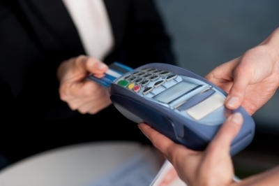 0385-corporate_lade_swiping_her_card_to_pay.jpg